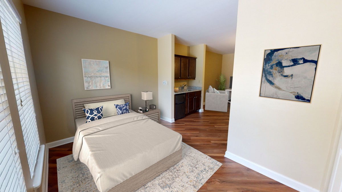 A modern bedroom featuring a cozy bed, wood flooring, and elegant decor.