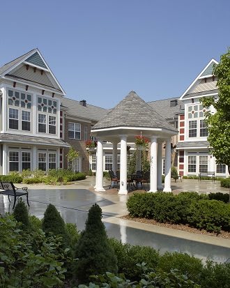 A charming residential building with landscaped gardens and a central courtyard.
