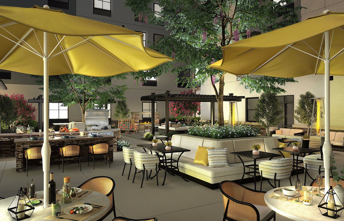A cozy outdoor restaurant patio with vibrant yellow umbrellas and stylish seating arrangements.