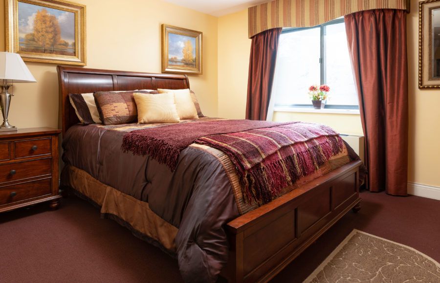 A cozy bedroom with warm colors and elegant decor.