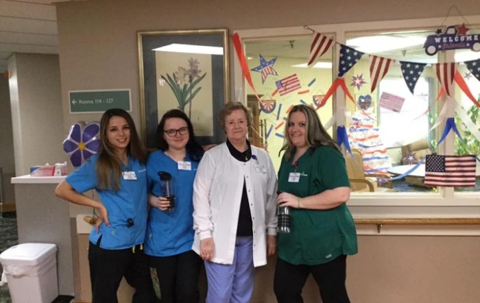 A group of healthcare professionals posing for a photo in a hospital setting.
