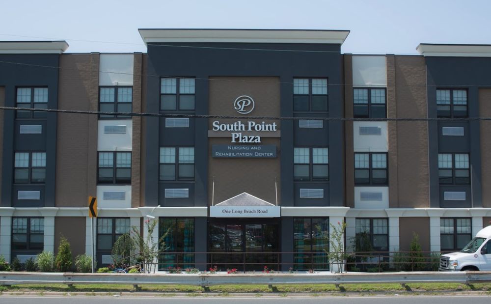 A modern hotel building with the name 'South Point Plaza' visible on the facade.