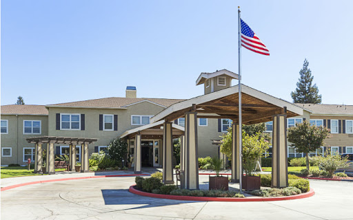 The welcoming entrance of a residential facility with an American flag.