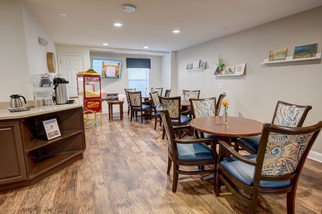 A cozy dining area with modern decor, featuring a popcorn machine and coffee station.