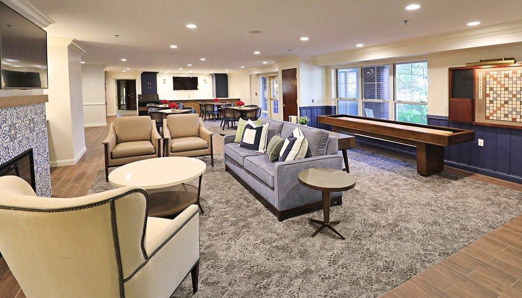 A modern living room with comfortable seating and large windows.