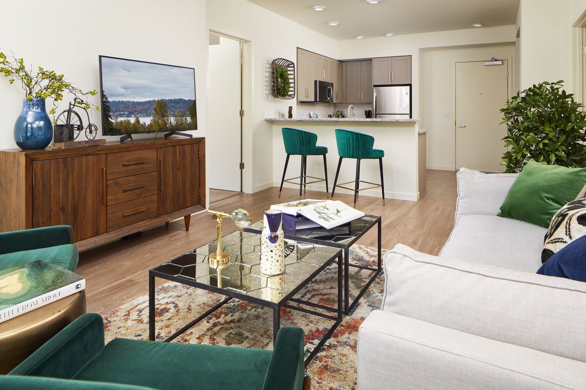 A modern open-concept living room and kitchen with stylish furniture and decor.