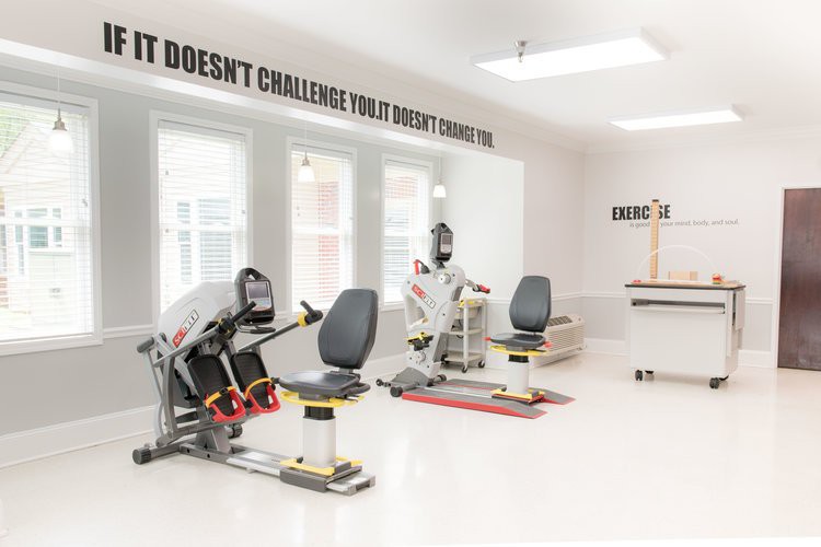 A bright and modern gym with various exercise machines ready for use.
