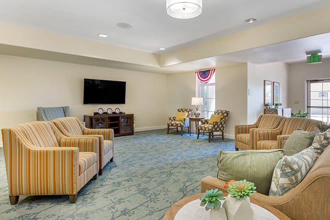 A cozy living room featuring comfortable seating, a television, and tasteful decor.