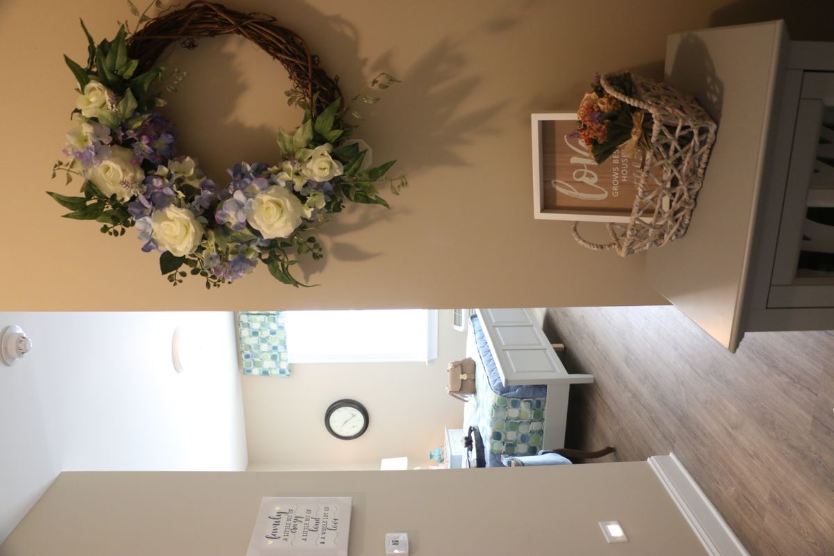 A cozy entryway with a floral wreath and decorative accents.