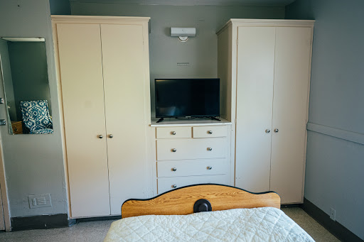 A cozy bedroom setup featuring a TV and ample storage.