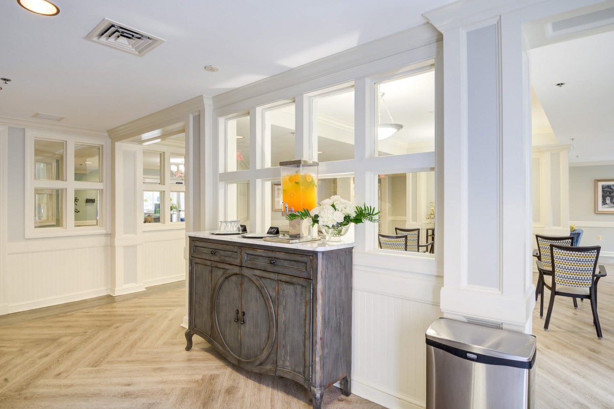 A bright and welcoming lobby area featuring a decorative console table with flowers.