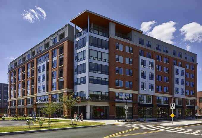A modern residential apartment building located in an urban setting.