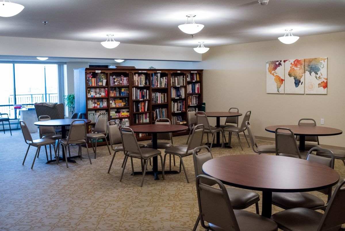 A cozy community library space with tables and chairs for reading and study.