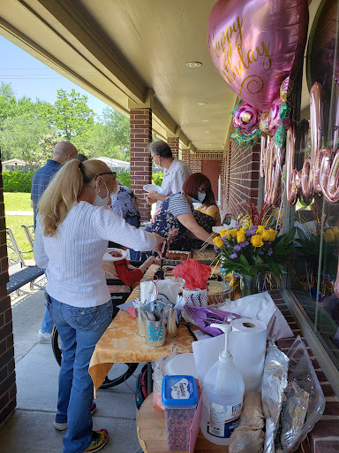 A community gathering with people preparing for a celebration outdoors.