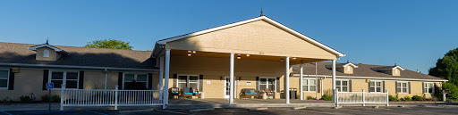 A modern building with a welcoming entrance, illuminated by the sunlight.