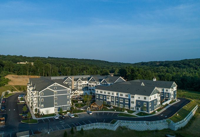 Aerial view of a residential housing complex surrounded by lush greenery.