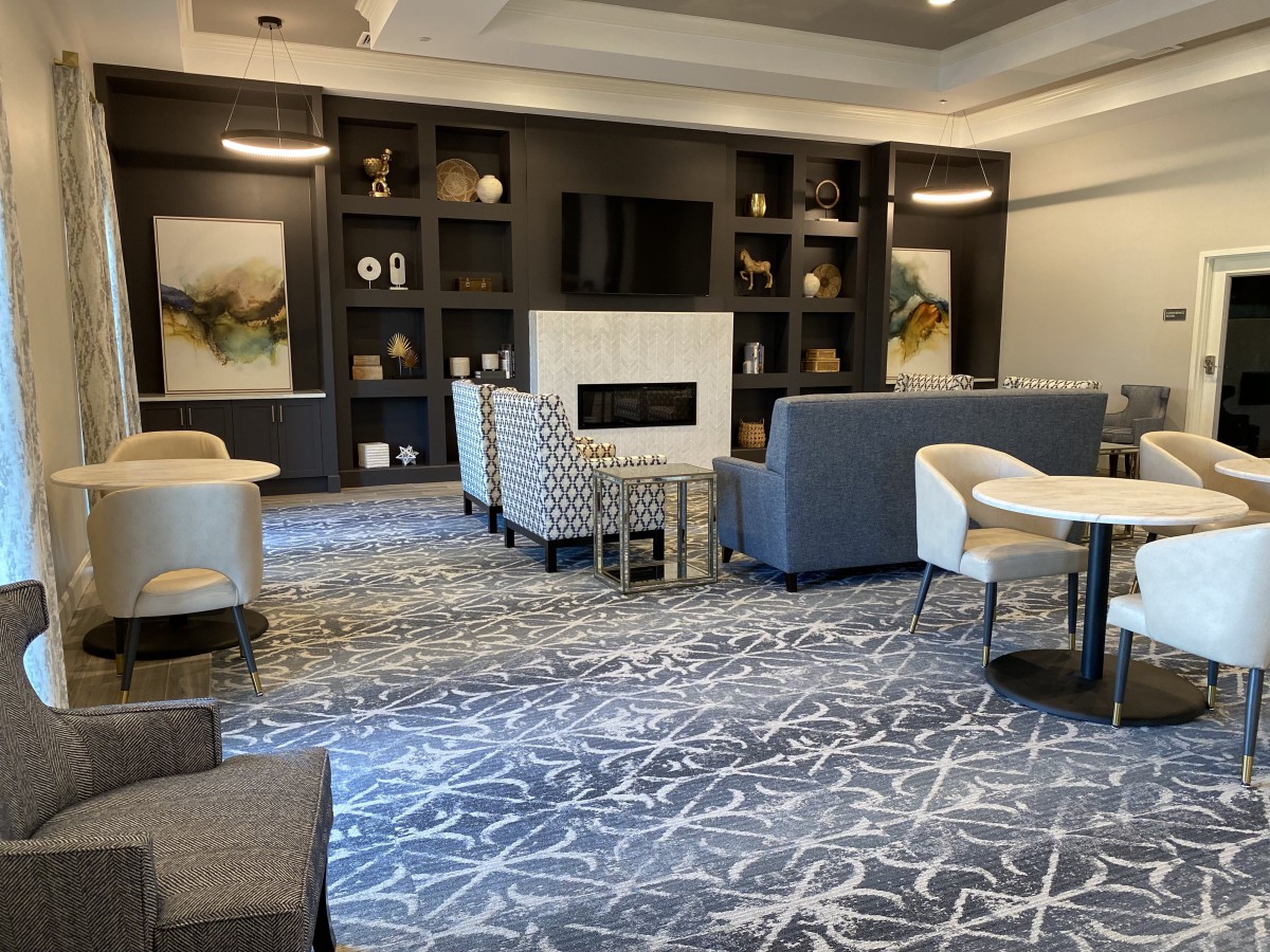 A modern lounge with comfortable seating and a fireplace.