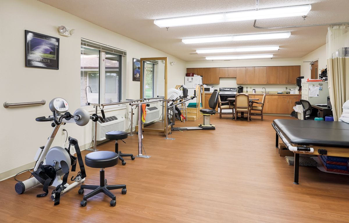 A rehabilitation center with various exercise equipment and facilities for physical therapy.