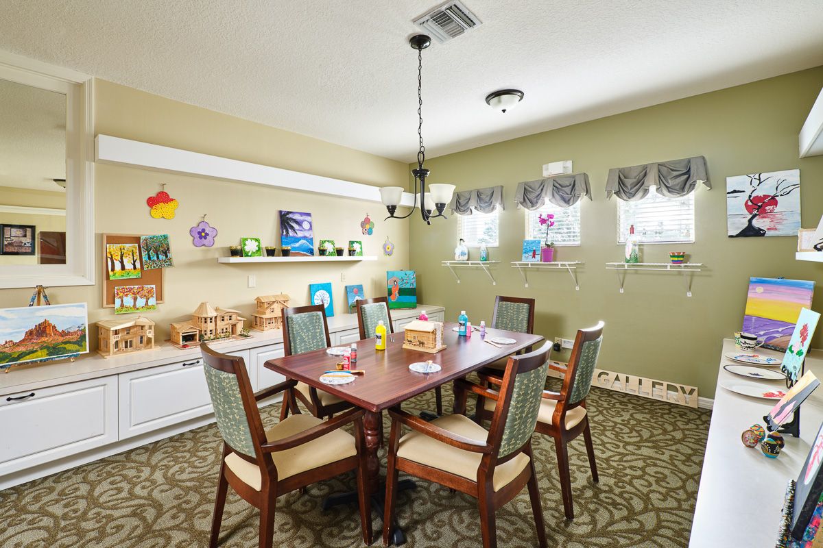 A cozy dining area designed for children, featuring a table with chairs, toys, and colorful decorations.