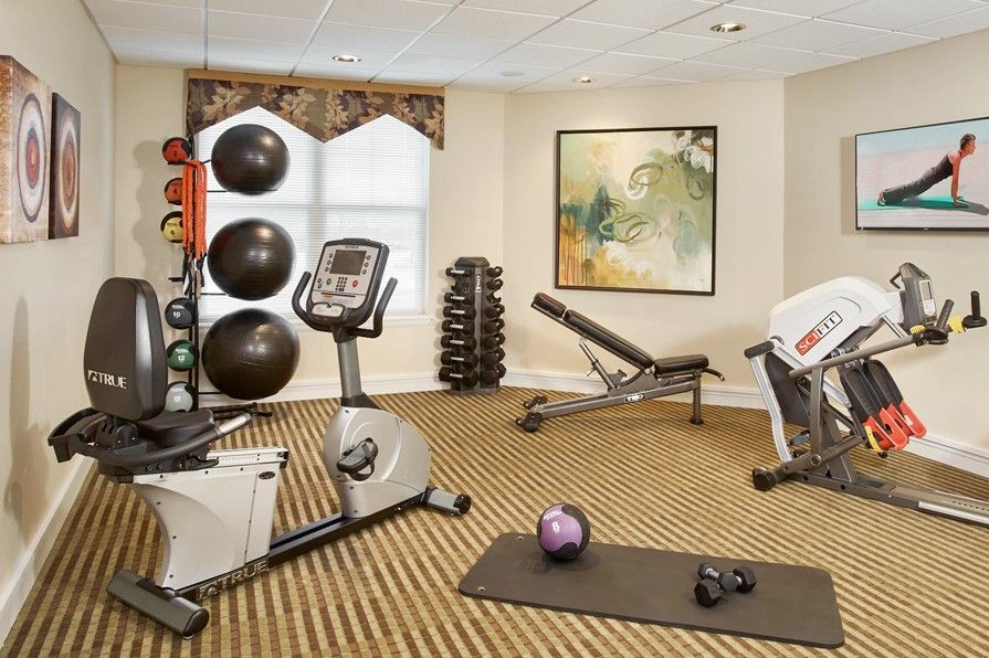 A well-equipped gym with exercise machines and free weights.