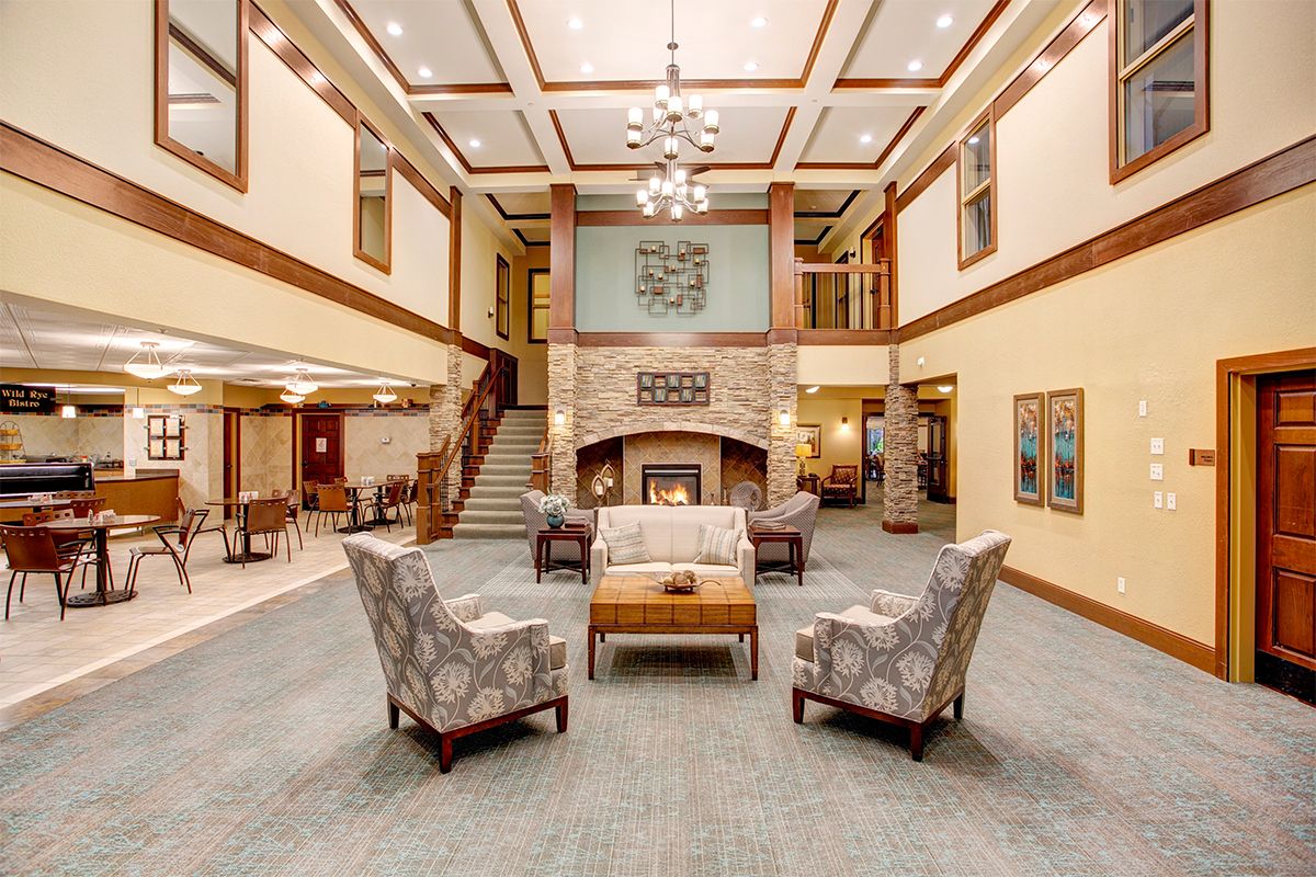 Spacious and elegantly designed lobby with a central seating area and fireplace.