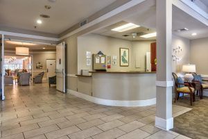 A view of a modern reception area with a desk and seating.