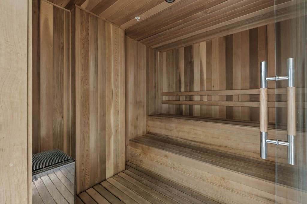 A wooden interior of a sauna designed for relaxation and wellness.