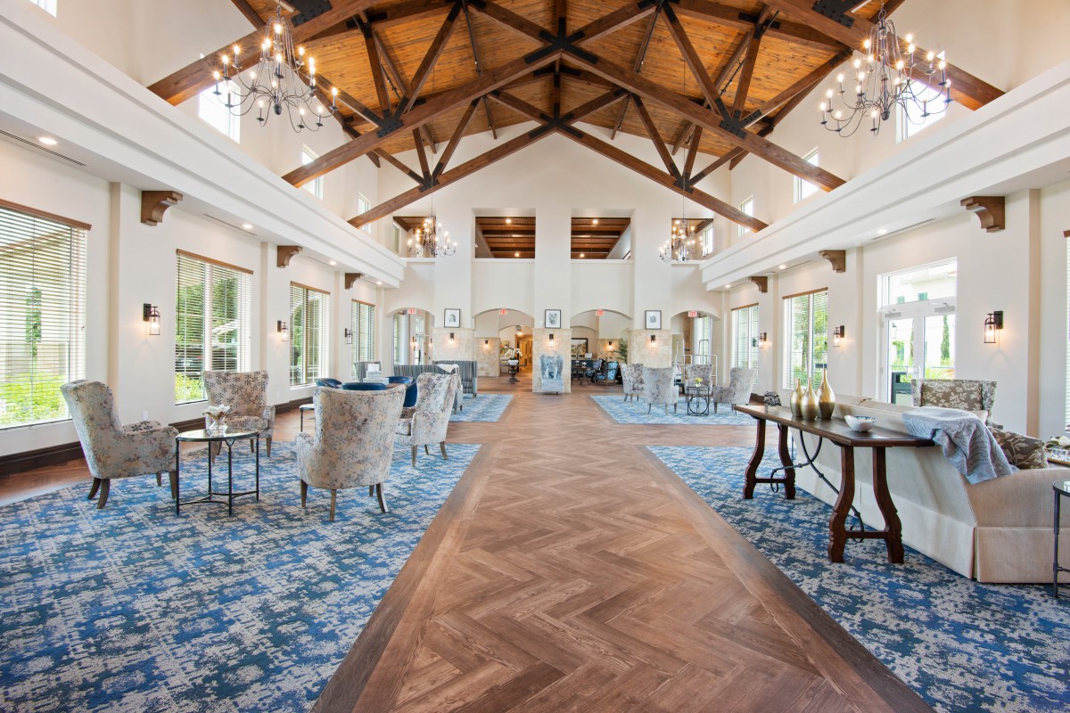 Spacious hall with high wooden ceilings and elegant chandeliers.