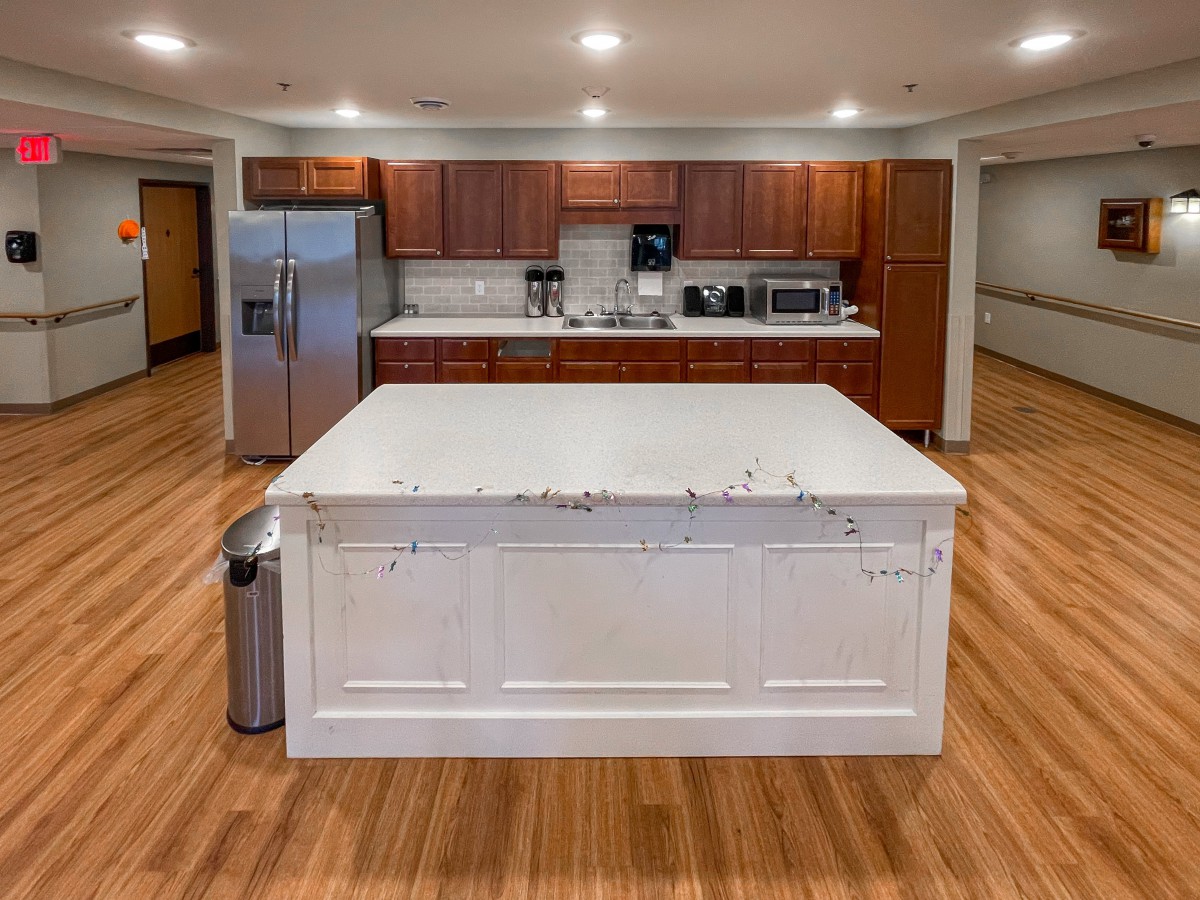 A modern kitchen with a large island and wooden cabinets.