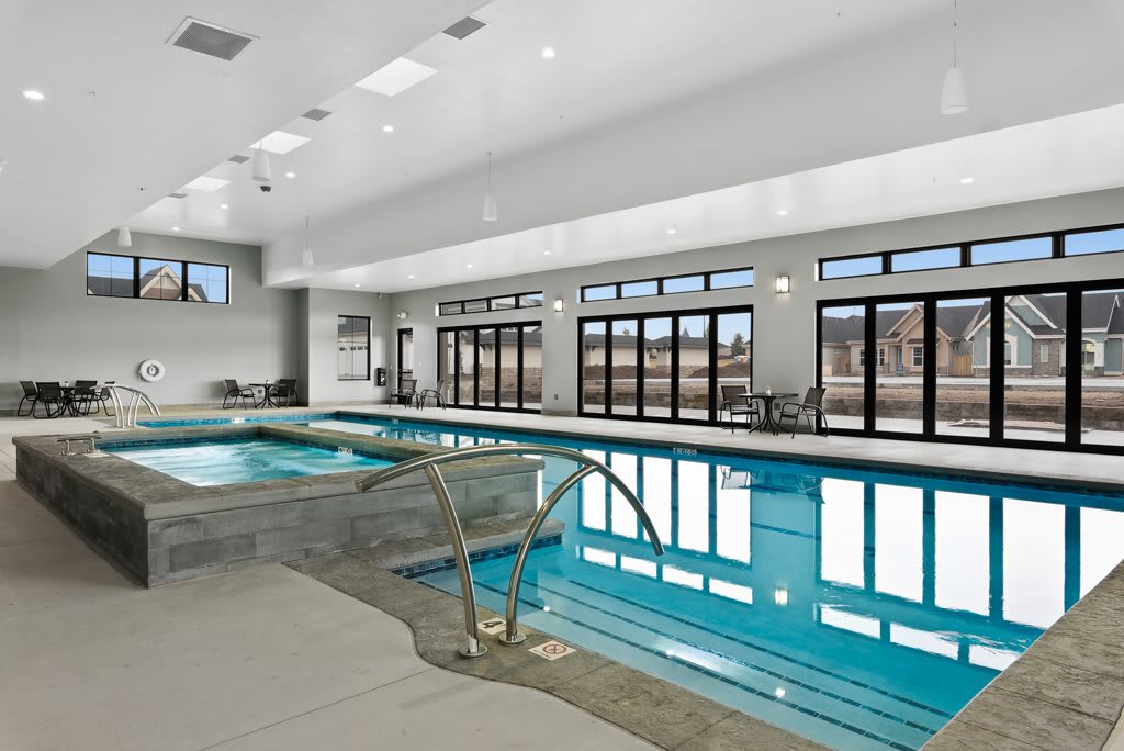 A luxurious indoor swimming pool with modern design and ample natural light.
