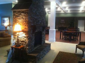 A cozy interior featuring a stone fireplace and warm lighting.