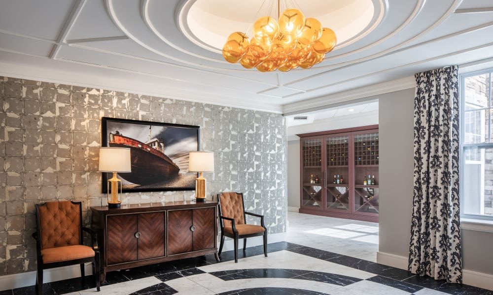 A luxurious lobby with elegant furniture and a striking chandelier.