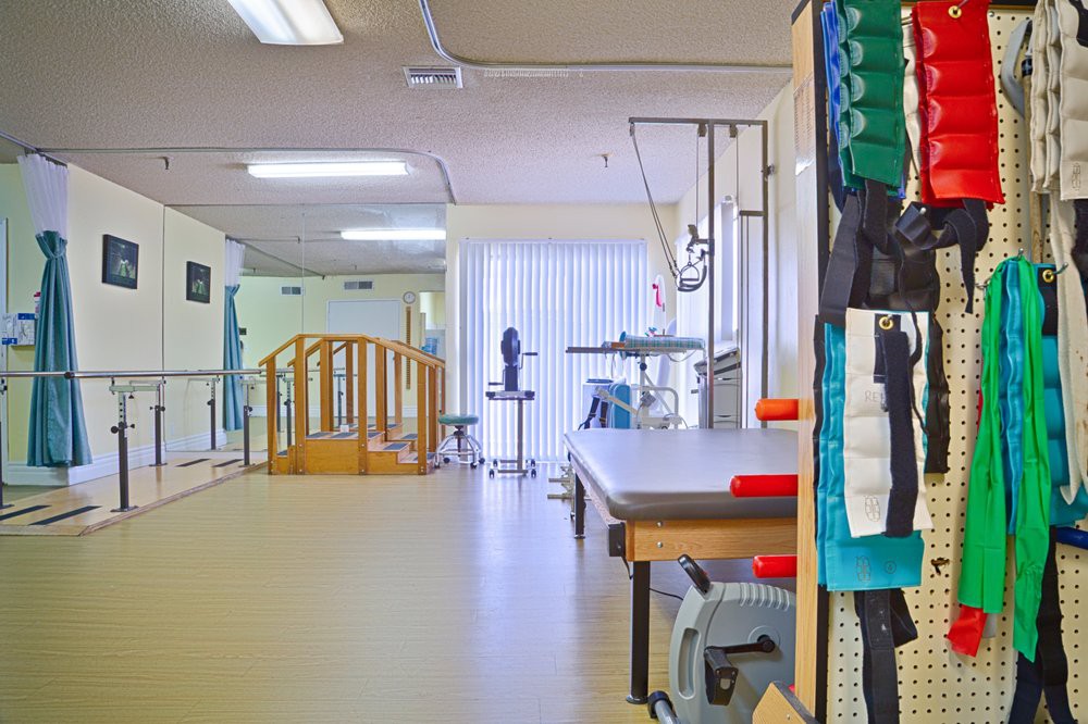 A physical therapy room equipped with various rehabilitation tools and exercise equipment.