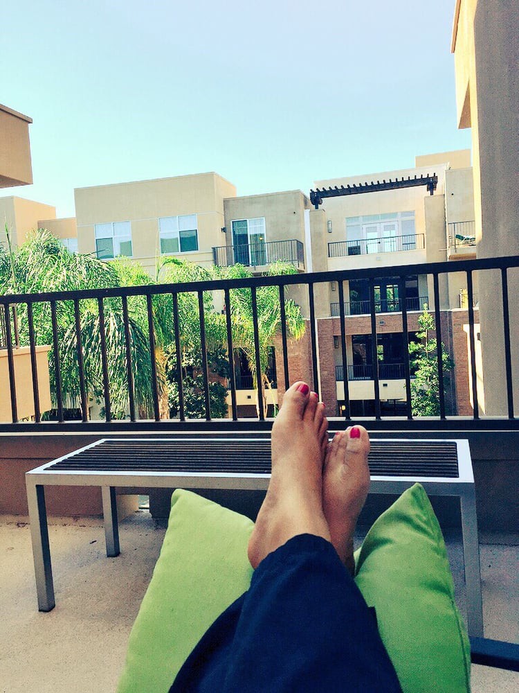 Relaxing on the balcony with a view of the cityscape.