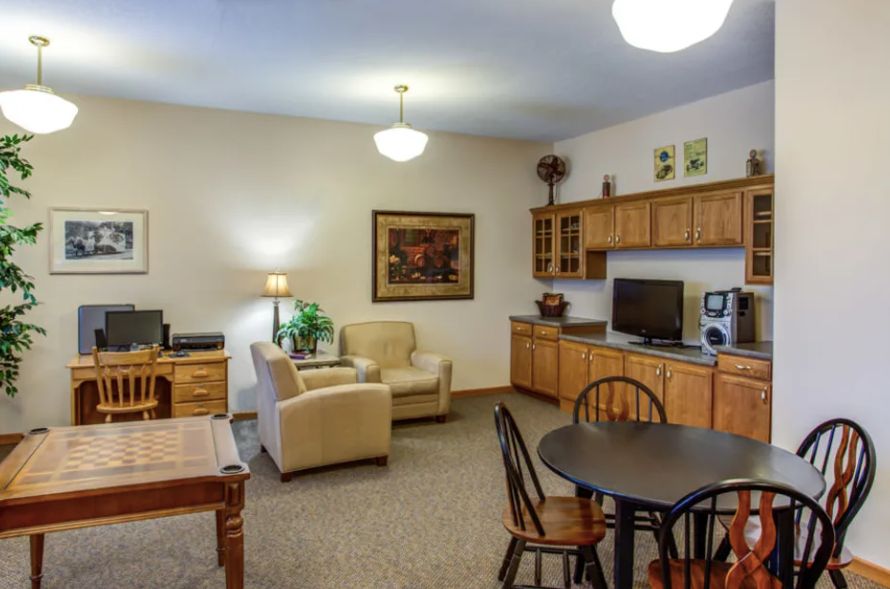 Cozy living area with a sofa, TV, and dining table in an apartment.