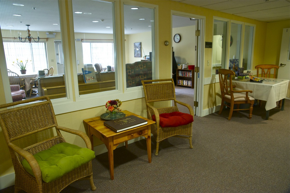 A cozy waiting area with colorful chairs and a small table.