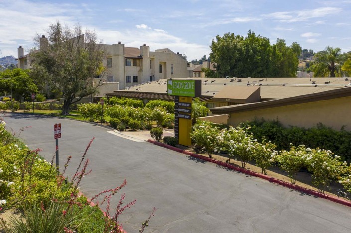 A landscaped entrance to a motel with clear signage and surrounding greenery.