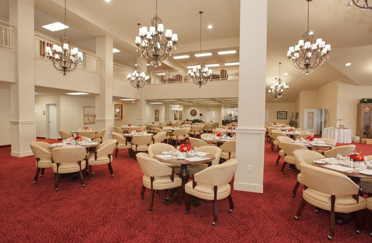 Spacious dining area with elegant chandeliers and comfortable seating.