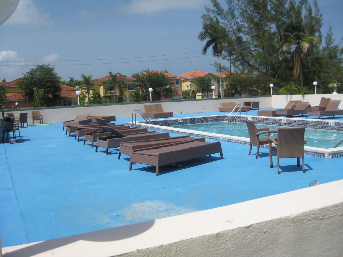 A tranquil outdoor pool area with lounge chairs perfect for relaxation.