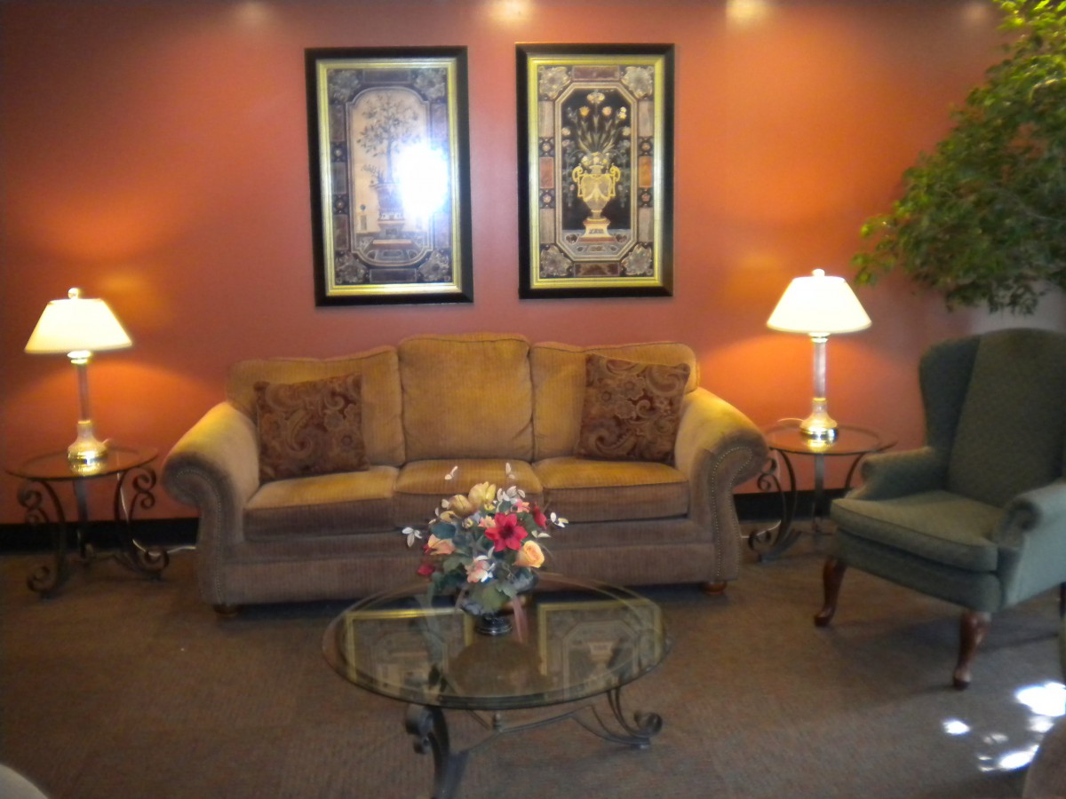 A cozy living room with a sofa, coffee table, and decorative wall art.