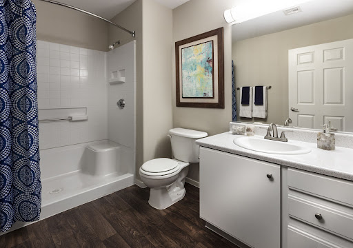 A clean and modern bathroom featuring a shower, toilet, and vanity.