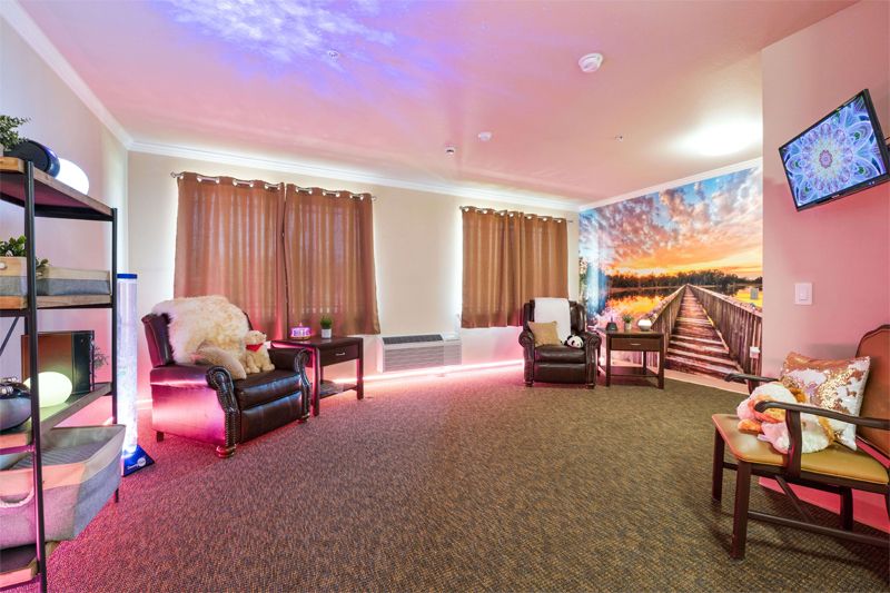Cozy lounge area with comfortable seating and vibrant mural.