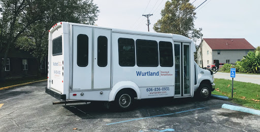 A Wurtland transportation bus parked, ready for passenger service.
