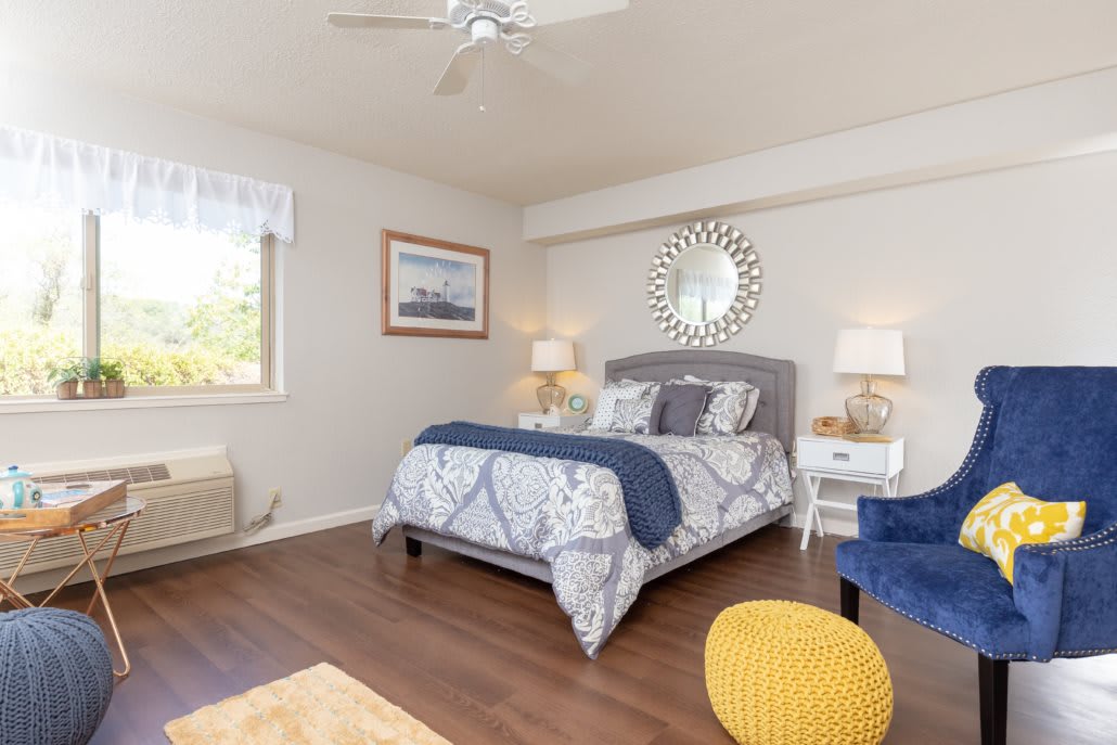 A cozy bedroom with modern decor and a spacious layout.
