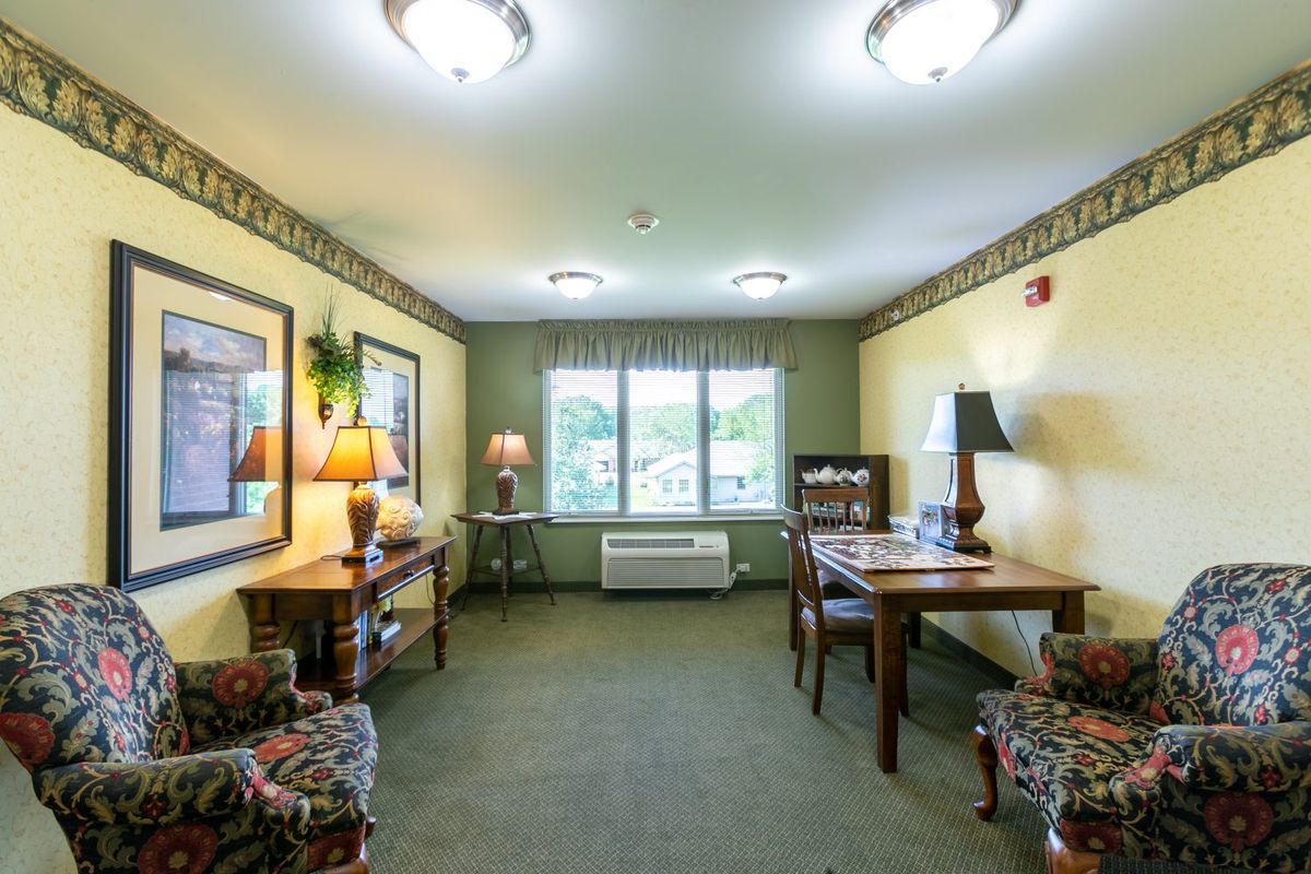 A cozy living room with comfortable seating, tables, and decorative lamps.