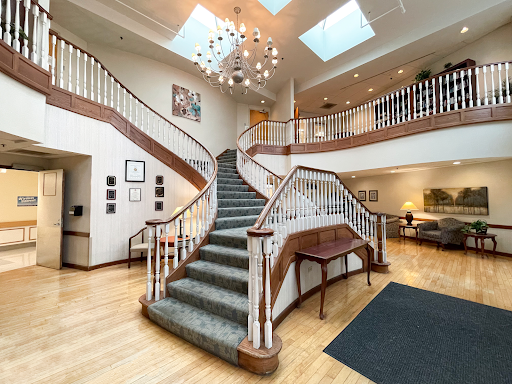 A beautifully designed lobby featuring an elegant staircase and modern lighting.