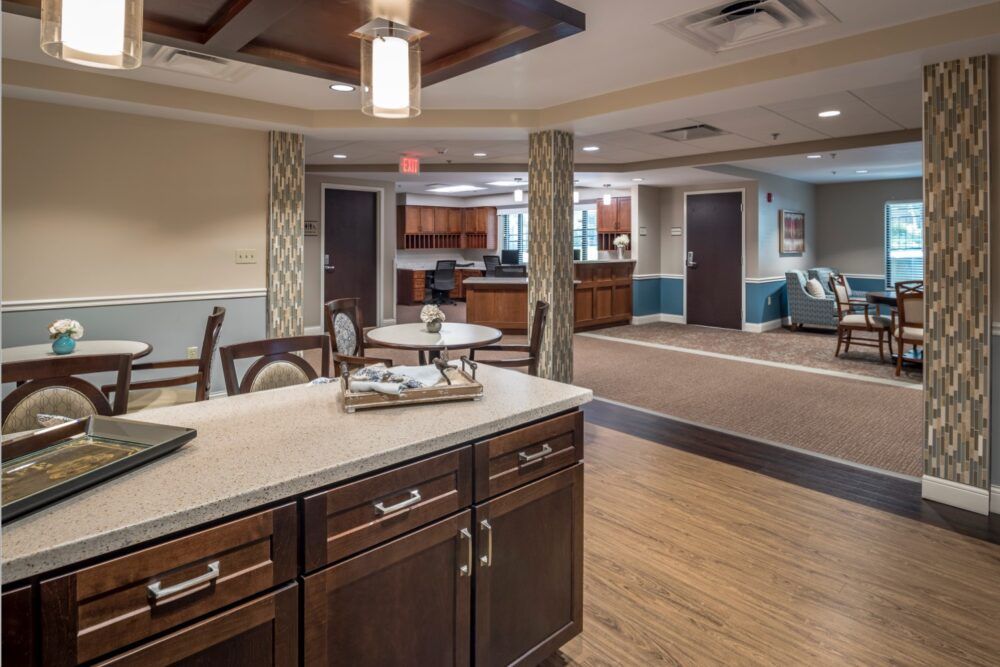 A modern open space interior featuring a kitchen and living area with stylish furnishings.