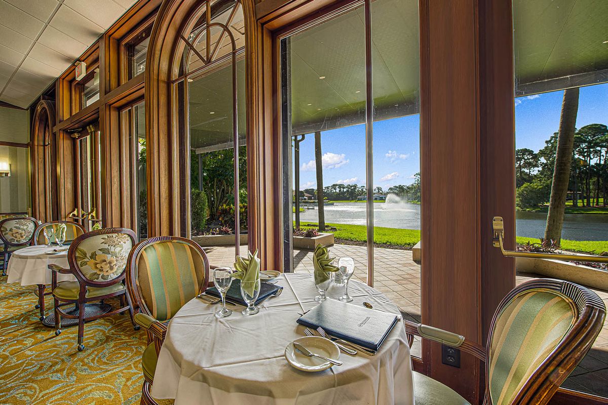 Elegant dining setup with a view of a serene outdoor landscape.