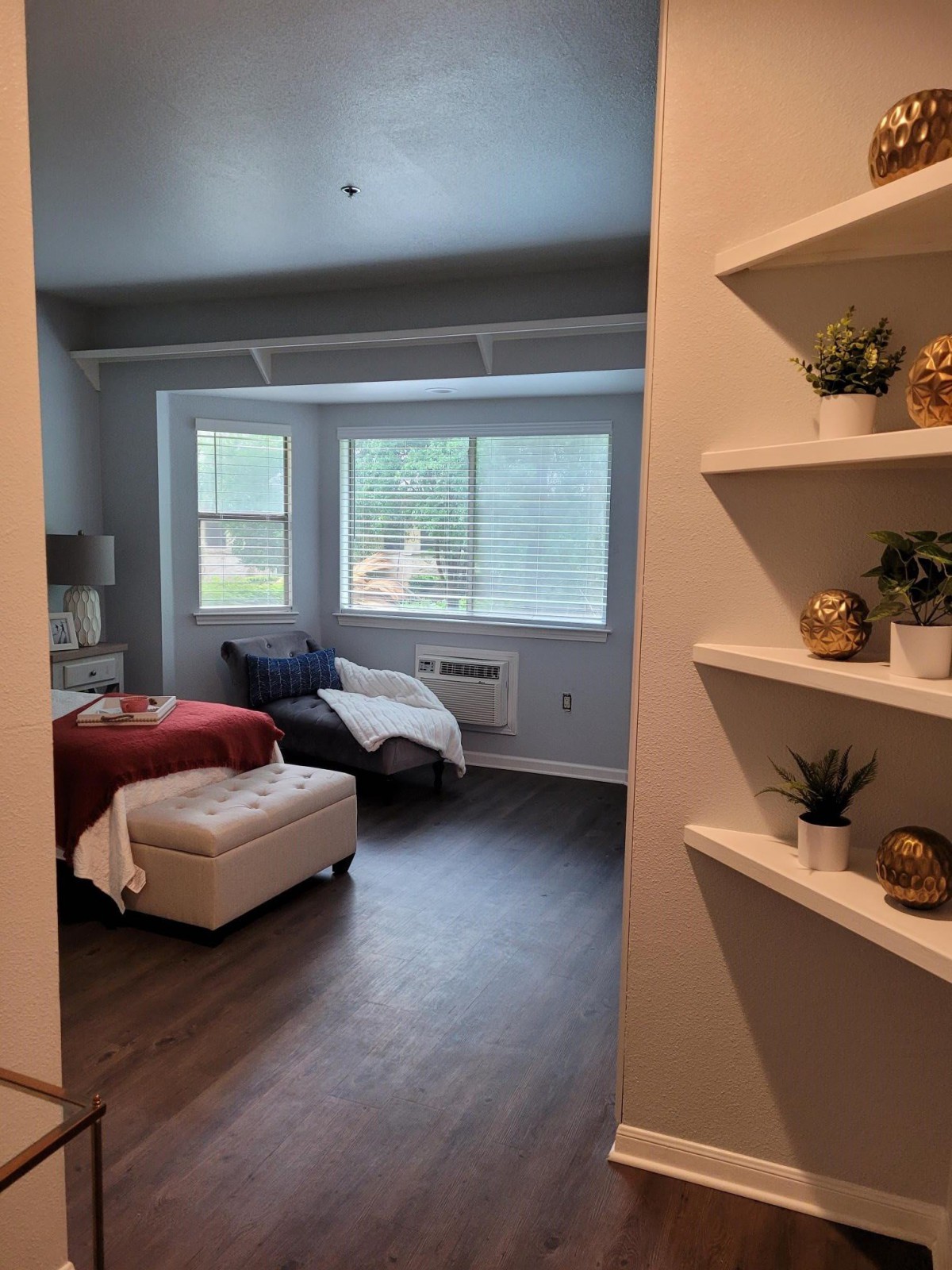 A cozy bedroom with stylish decor and natural light.
