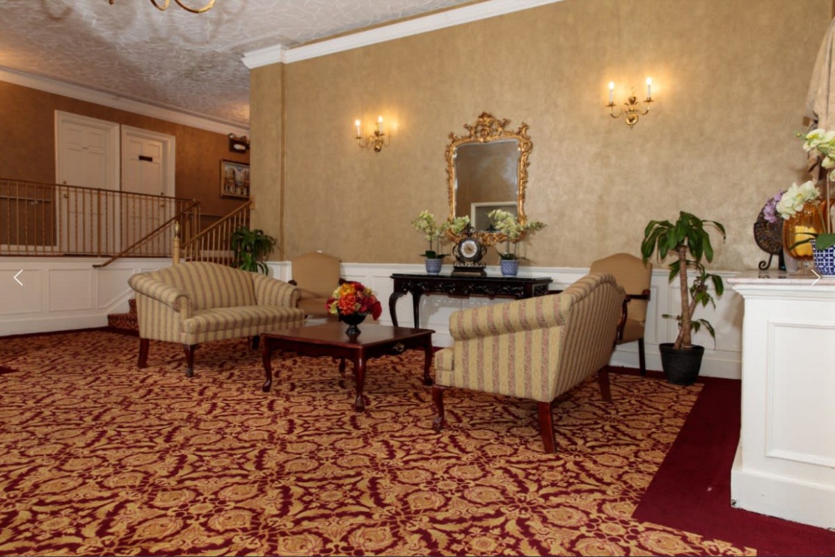 A classic hotel lobby with elegant furniture and ornate decor.